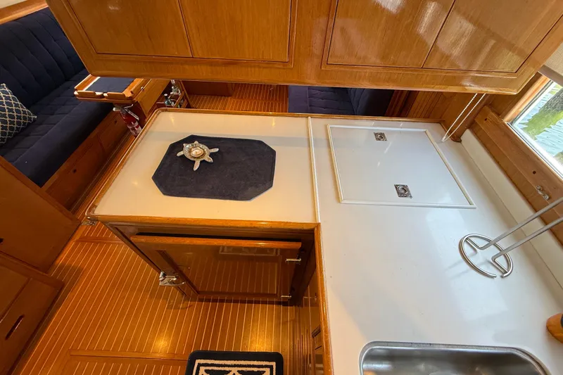 Revere Yacht Photos Pics Interior of 2002 Grand Banks 42 Classic yacht with wooden cabinetry and seating.