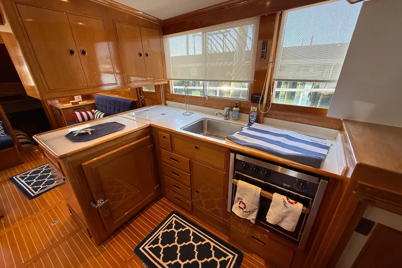 Revere Yacht Photos Pics Luxurious 2002 Grand Banks 42 Classic yacht kitchen with wood cabinetry and modern appliances.