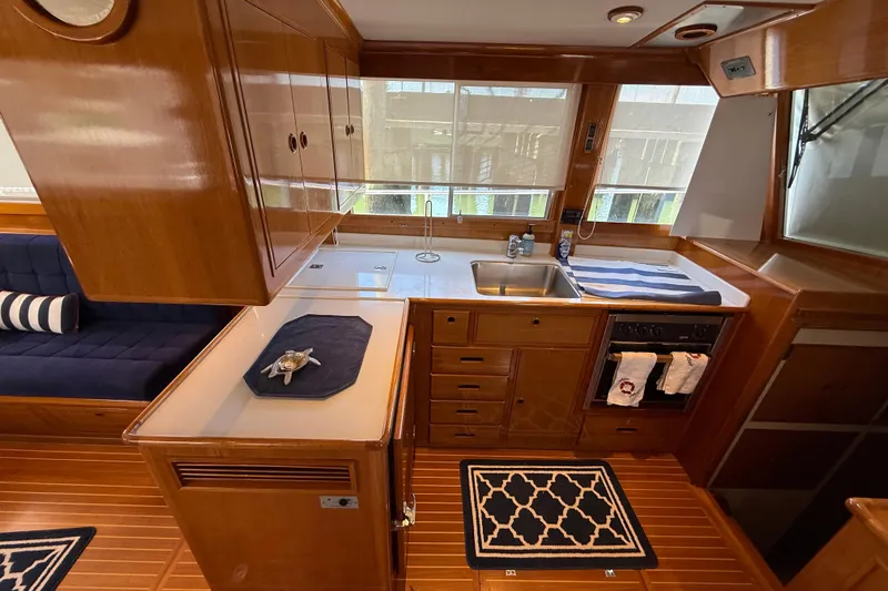 Revere Yacht Photos Pics Interior of 2002 Grand Banks 42 Classic yacht with wooden cabinetry and modern kitchen amenities.