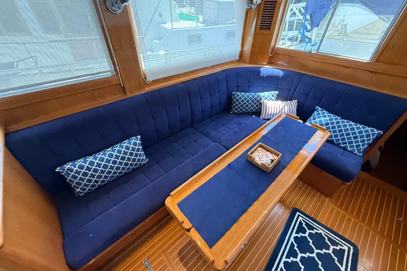 Revere Yacht Photos Pics Luxurious interior of 2002 Grand Banks 42 Classic yacht with blue seating and decorative pillows.
