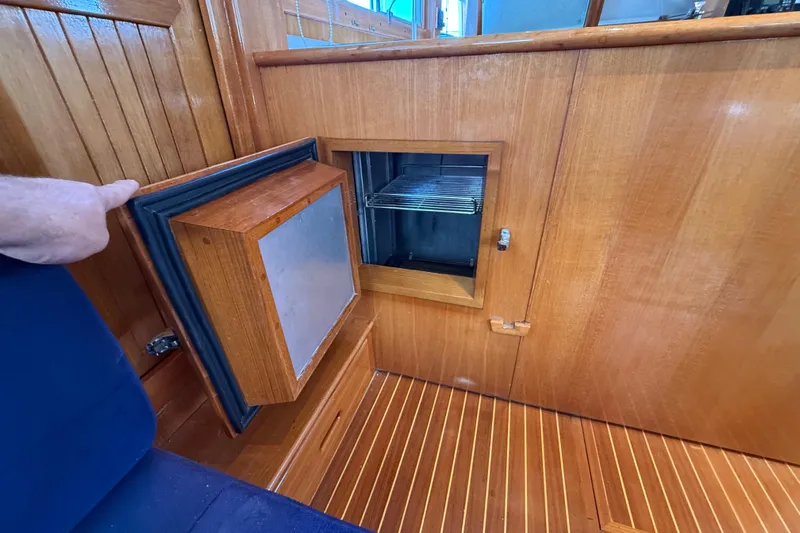 Revere Yacht Photos Pics Wooden interior of 2002 Grand Banks 42 Classic yacht with open storage compartment.