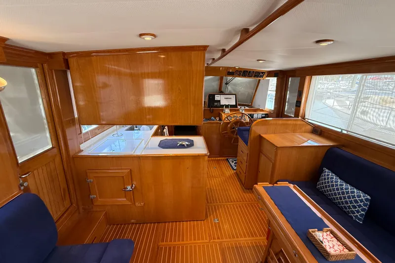 Revere Yacht Photos Pics Interior of 2002 Grand Banks 42 Classic yacht with wooden finish and blue seating.