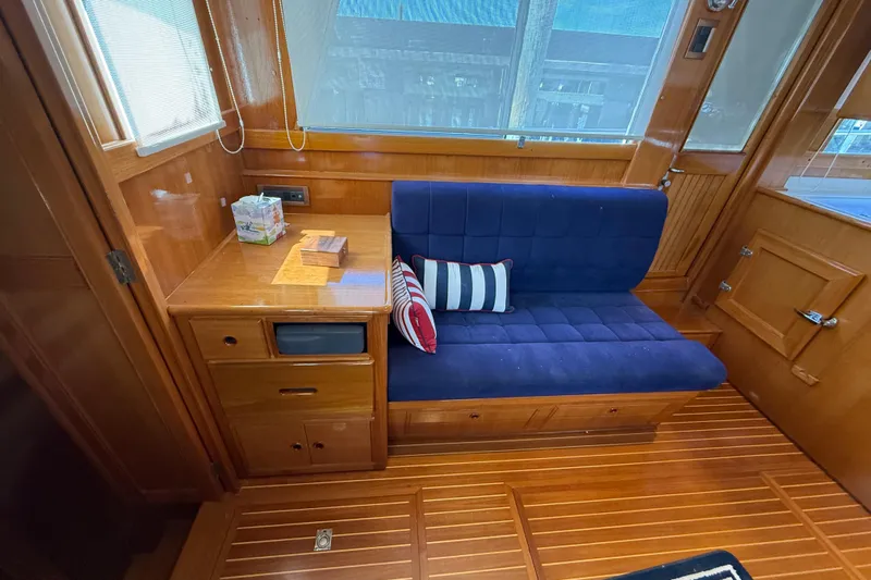 Revere Yacht Photos Pics Interior of 2002 Grand Banks 42 Classic yacht with blue seating and wooden cabinetry.