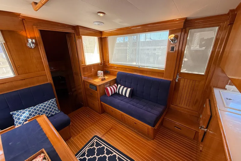 Revere Yacht Photos Pics Luxurious interior of 2002 Grand Banks 42 Classic yacht with wooden finish and navy seating.