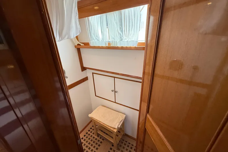 Revere Yacht Photos Pics Interior of 2002 Grand Banks 42 Classic yacht, featuring wooden cabinetry and a window with curtains.