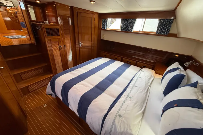 Revere Yacht Photos Pics Luxurious cabin interior of 2002 Grand Banks 42 Classic yacht with striped bedding.