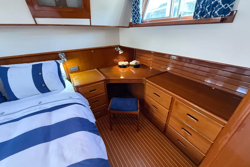 Revere Yacht Photos Pics Luxurious cabin interior of 2002 Grand Banks 42 Classic yacht with wood finish and cozy bedding.