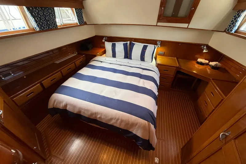 Revere Yacht Photos Pics Luxurious cabin interior of 2002 Grand Banks 42 Classic yacht with striped bedding.
