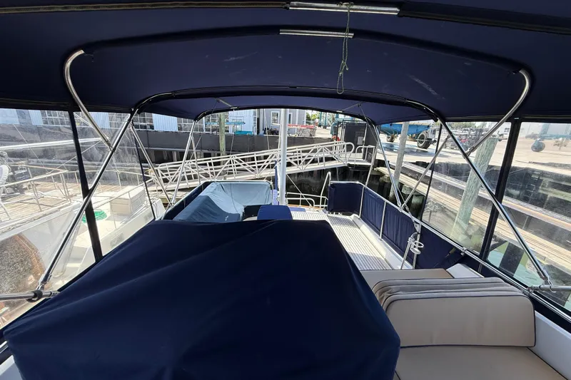 Revere Yacht Photos Pics 2002 Grand Banks 42 Classic yacht interior with blue canopy and seating area.