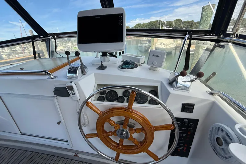 Revere Yacht Photos Pics Helm of 2002 Grand Banks 42 Classic yacht with wooden wheel and navigation equipment.