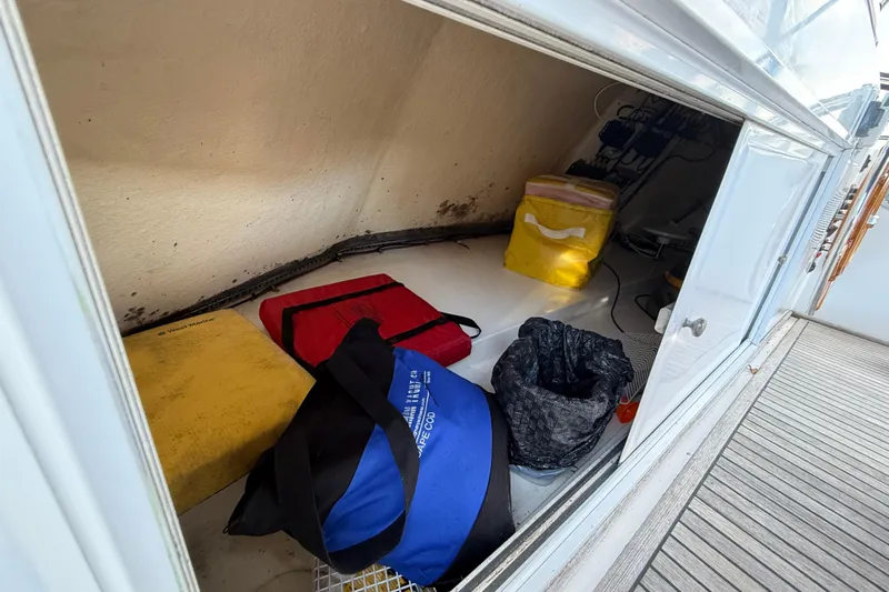 Revere Yacht Photos Pics Storage compartment on a 2002 Grand Banks 42 Classic boat with various bags and equipment.