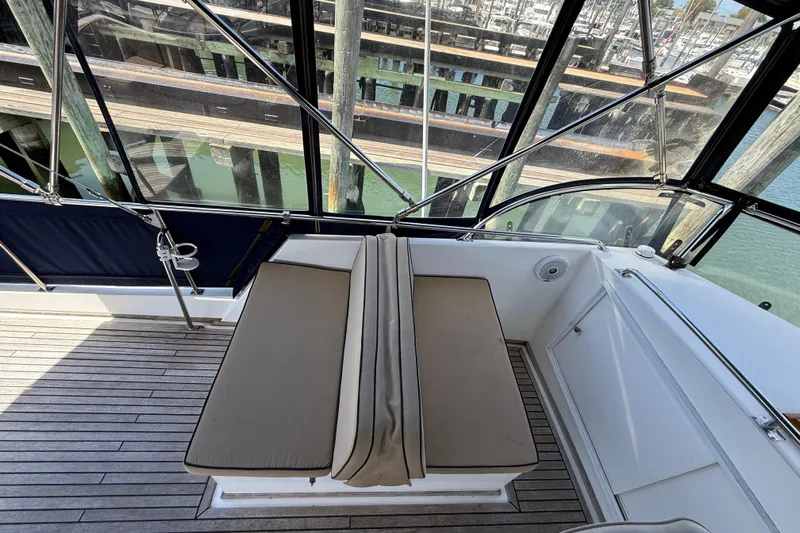 Revere Yacht Photos Pics 2002 Grand Banks 42 Classic yacht with cushioned seating and teak deck, docked at marina.