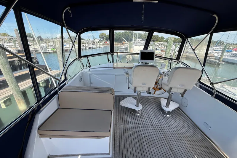 Revere Yacht Photos Pics Grand Banks 42 Classic 2002 yacht helm with seating, overlooking marina.