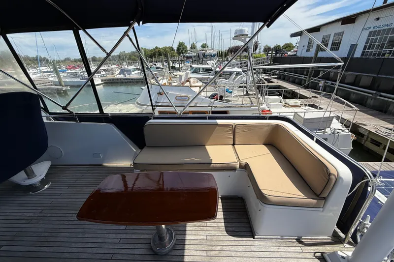 Revere Yacht Photos Pics Grand Banks 42 Classic 2002 yacht deck with seating and table at marina.