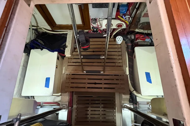 Revere Yacht Photos Pics Engine room of a 2002 Grand Banks 42 Classic yacht with wooden flooring and equipment.