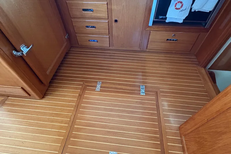 Revere Yacht Photos Pics Wooden interior of 2002 Grand Banks 42 Classic yacht, featuring polished cabinetry and flooring.
