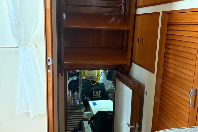 Revere Yacht Photos Pics Engine room access on 2002 Grand Banks 42 Classic yacht, featuring wooden cabinetry.