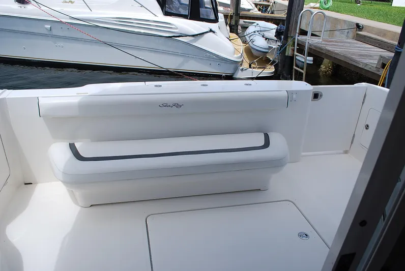  Yacht Photos Pics 2004 Sea Ray Sedan Bridge boat with white seating and docked at a marina.