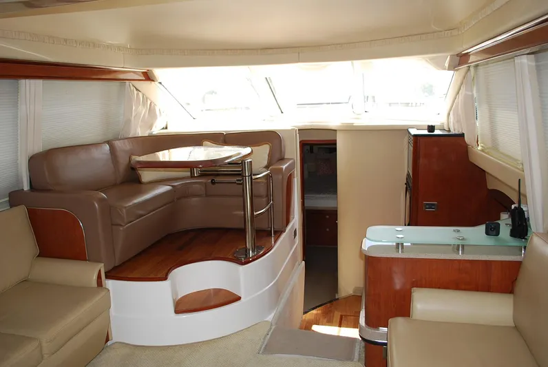  Yacht Photos Pics Interior of 2004 Sea Ray Sedan Bridge yacht with leather seating and wooden accents.