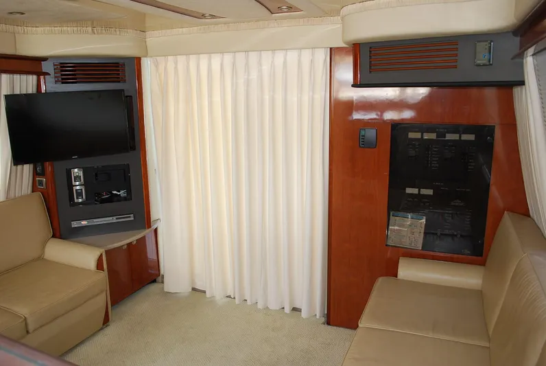  Yacht Photos Pics Interior of 2004 Sea Ray Sedan Bridge yacht with beige seating and entertainment system.