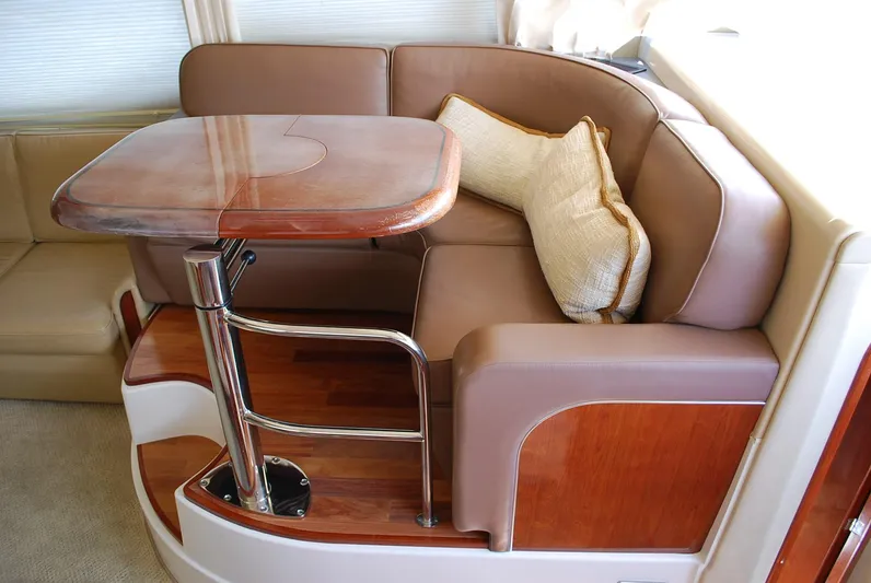  Yacht Photos Pics Luxurious 2004 Sea Ray Sedan Bridge interior with elegant seating and wooden table.