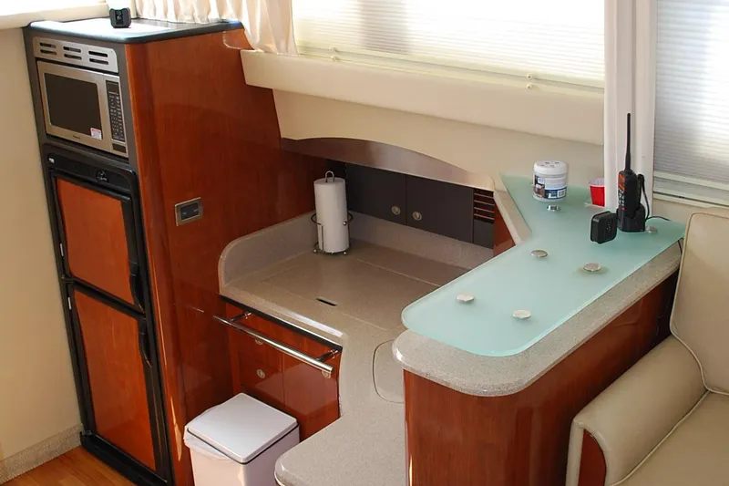  Yacht Photos Pics 2004 Sea Ray Sedan Bridge yacht interior with kitchenette, featuring microwave and modern design.