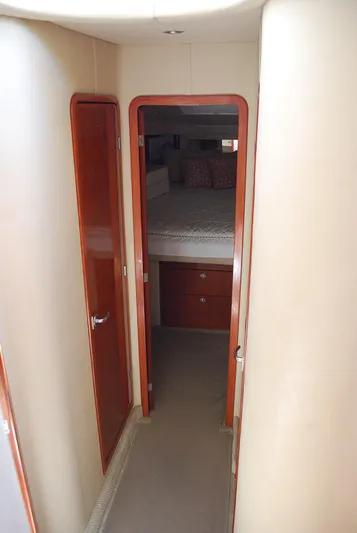  Yacht Photos Pics 2004 Sea Ray Sedan Bridge interior hallway leading to a cozy bedroom.