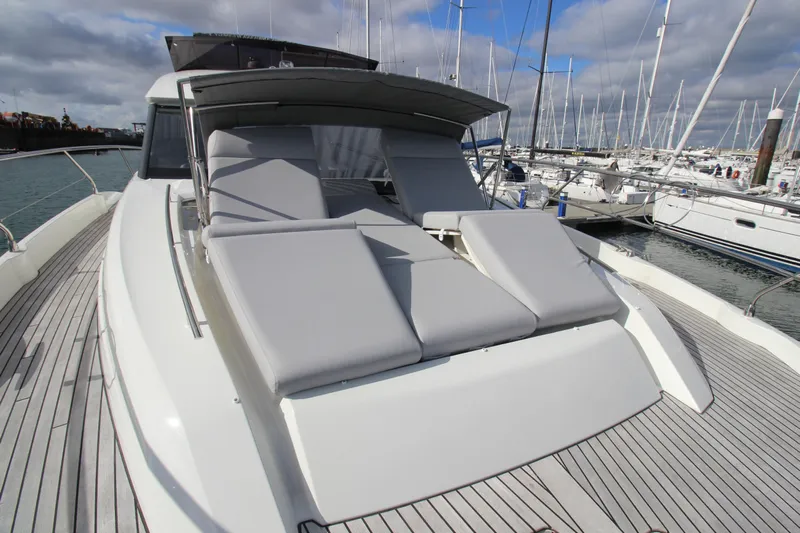  Yacht Photos Pics Luxury Prestige 520 yacht with sun loungers, docked in marina, 2025 model.