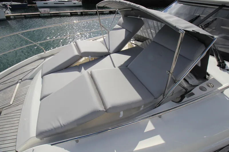  Yacht Photos Pics Luxury sunbathing area on 2025 Prestige 520 yacht, featuring comfortable gray cushions.
