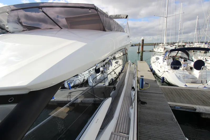  Yacht Photos Pics Luxury Prestige 520 yacht docked at marina, 2025 model, sleek design, sunny day.