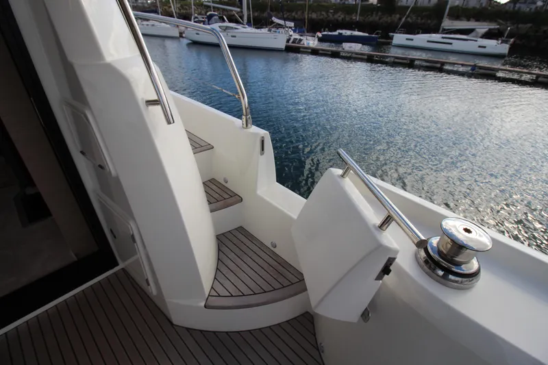  Yacht Photos Pics Staircase on 2025 Prestige 520 yacht, docked with scenic water view.