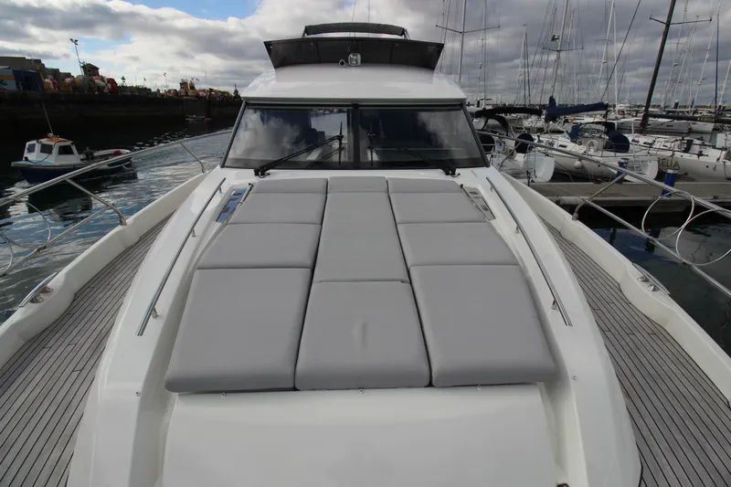  Yacht Photos Pics 2025 Prestige 520 yacht with spacious deck, docked in a marina.