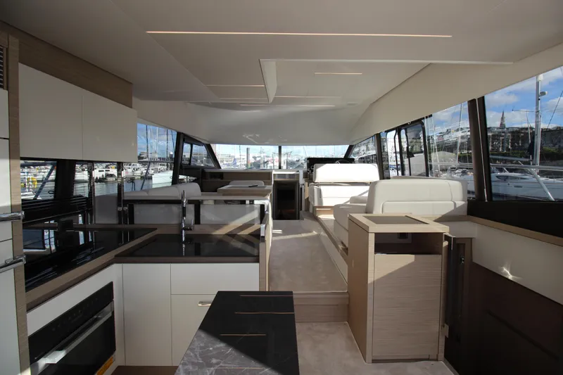  Yacht Photos Pics Luxurious interior of 2025 Prestige 520 yacht with modern kitchen and spacious seating area.