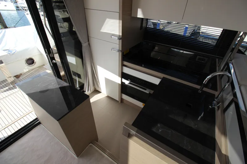  Yacht Photos Pics Modern kitchen interior on 2025 Prestige 520 yacht, featuring sleek countertops and cabinetry.