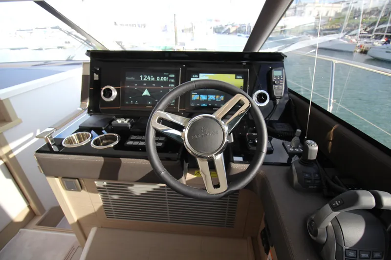  Yacht Photos Pics Cockpit of 2025 Prestige 520 yacht with modern navigation controls and steering wheel.