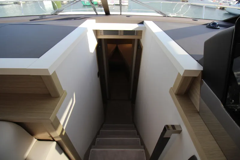  Yacht Photos Pics Staircase leading to lower deck of 2025 Prestige 520 yacht interior.