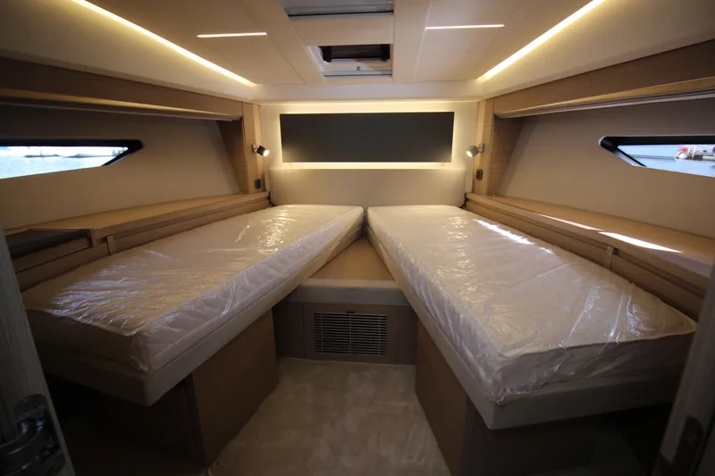  Yacht Photos Pics Luxurious twin cabin interior of 2025 Prestige 520 yacht, featuring modern lighting and sleek design.