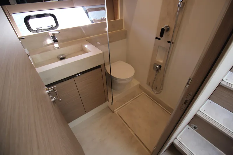  Yacht Photos Pics Modern bathroom in 2025 Prestige 520 yacht with shower, sink, and toilet.