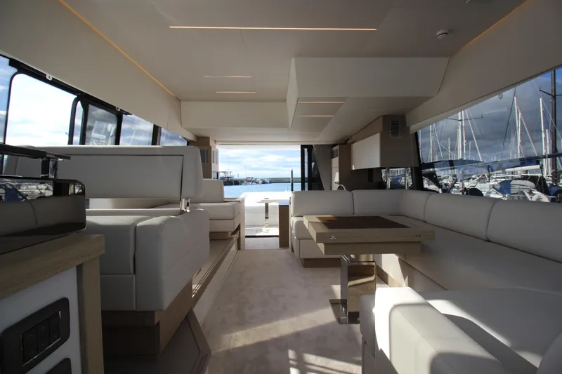  Yacht Photos Pics Luxurious interior of a 2025 Prestige 520 yacht with elegant seating and panoramic windows.
