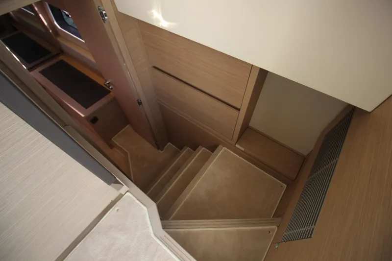 Yacht Photos Pics Staircase inside 2025 Prestige 520 yacht, featuring modern wooden design and sleek finishes.