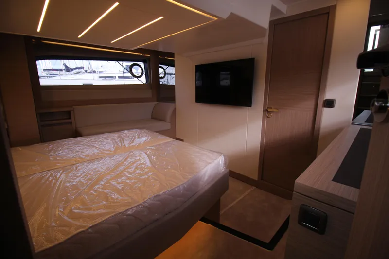  Yacht Photos Pics Luxurious interior of 2025 Prestige 520 yacht bedroom with modern design and ambient lighting.