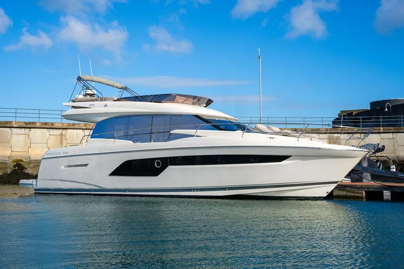  Yacht Photos Pics Luxury 2025 Prestige 520 yacht docked in a marina under a clear blue sky.