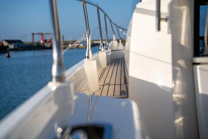  Yacht Photos Pics Side view of 2025 Prestige 520 yacht with sleek deck and railing.