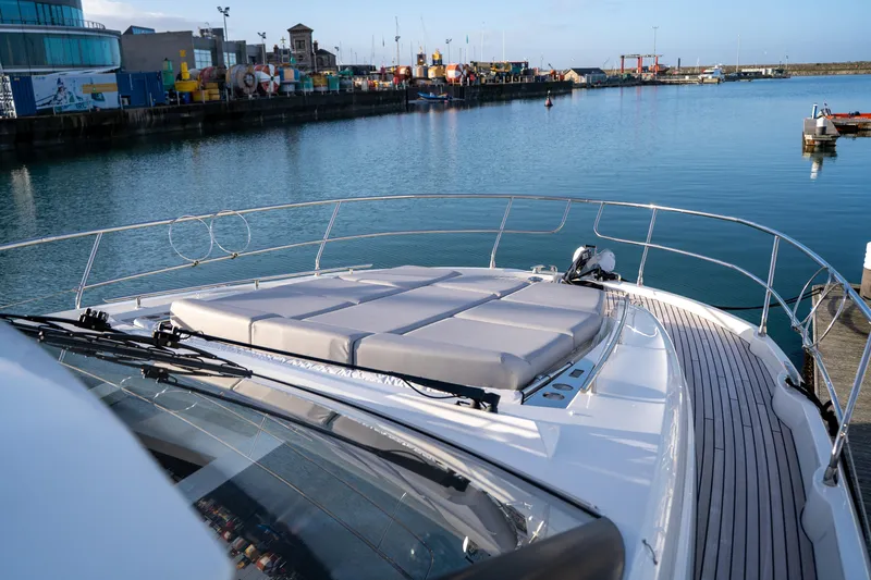  Yacht Photos Pics Luxury Prestige 520 yacht, 2025 model, docked in a serene harbor setting.