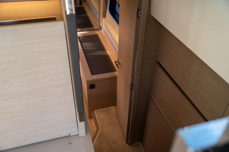  Yacht Photos Pics Interior of 2025 Prestige 520 yacht, featuring sleek wooden cabinetry and modern design.