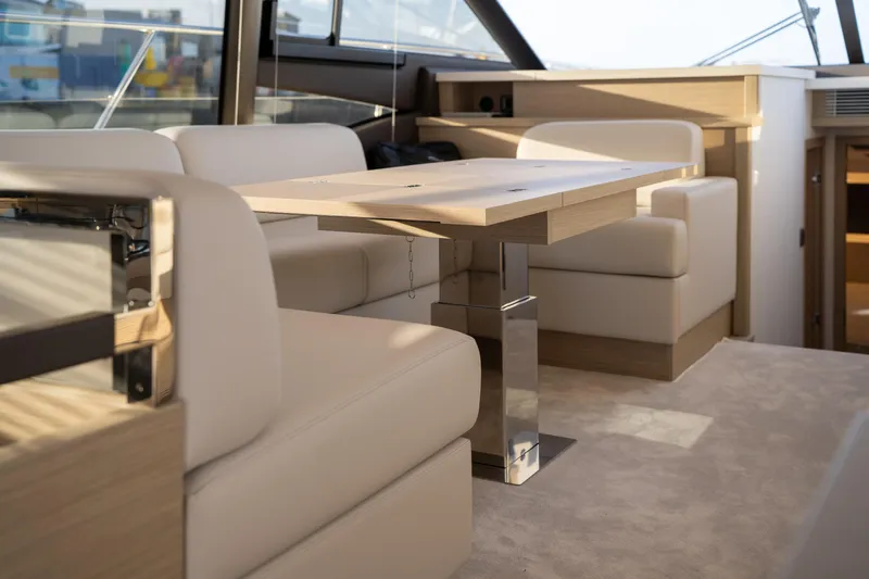  Yacht Photos Pics Luxurious interior of 2025 Prestige 520 yacht with modern seating and wooden table.