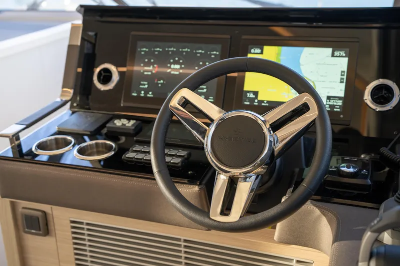  Yacht Photos Pics Steering wheel and dashboard of 2025 Prestige 520 yacht, featuring modern navigation displays.