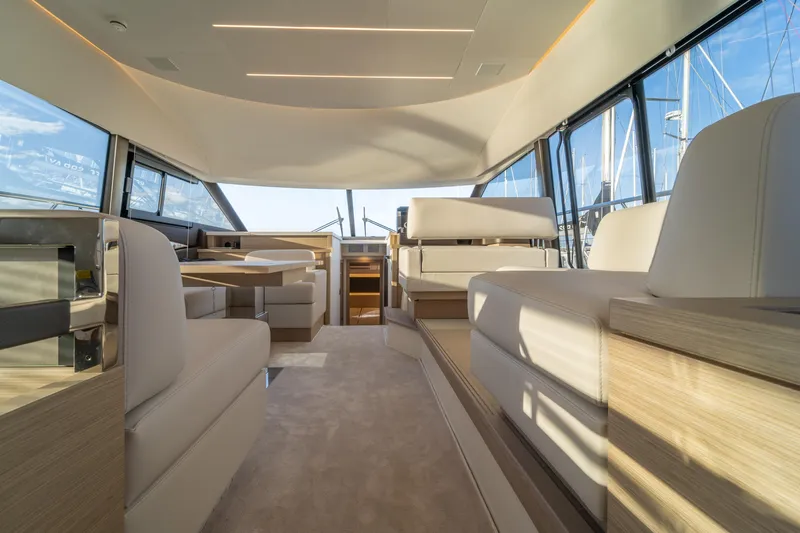 Yacht Photos Pics Luxurious interior of 2025 Prestige 520 yacht with modern seating and panoramic windows.