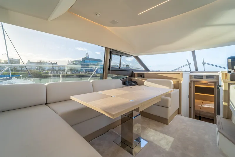  Yacht Photos Pics Luxurious interior of 2025 Prestige 520 yacht with modern seating and panoramic windows.