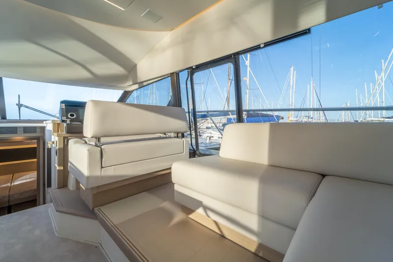  Yacht Photos Pics Luxurious interior of 2025 Prestige 520 yacht with elegant seating and marina view.